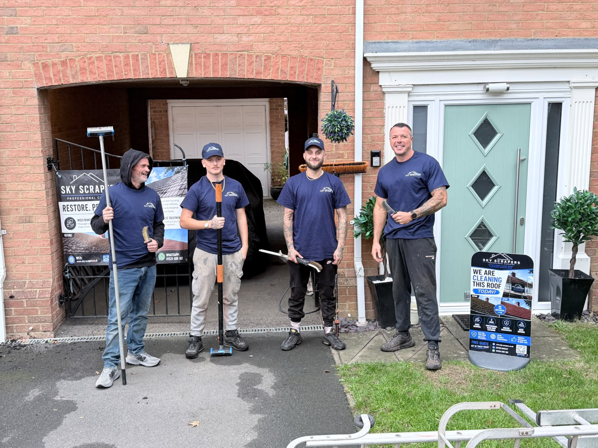 The Sky Scrapers Ltd team in branded uniforms outside a customer's home